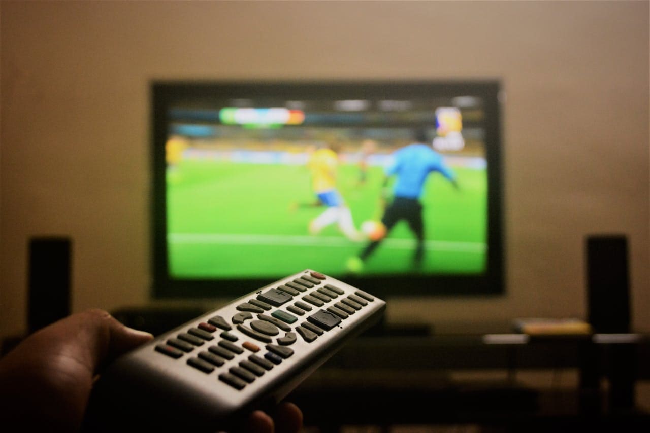 Photo of a Person's Hand Holding a Remote Control Photo of a Person's Hand Holding a Remote Control