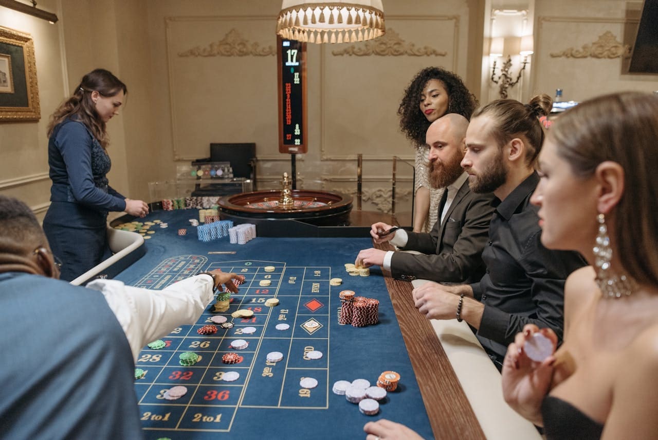 Players Placing their Bets on the Roulette Table Players Placing their Bets on the Roulette Table