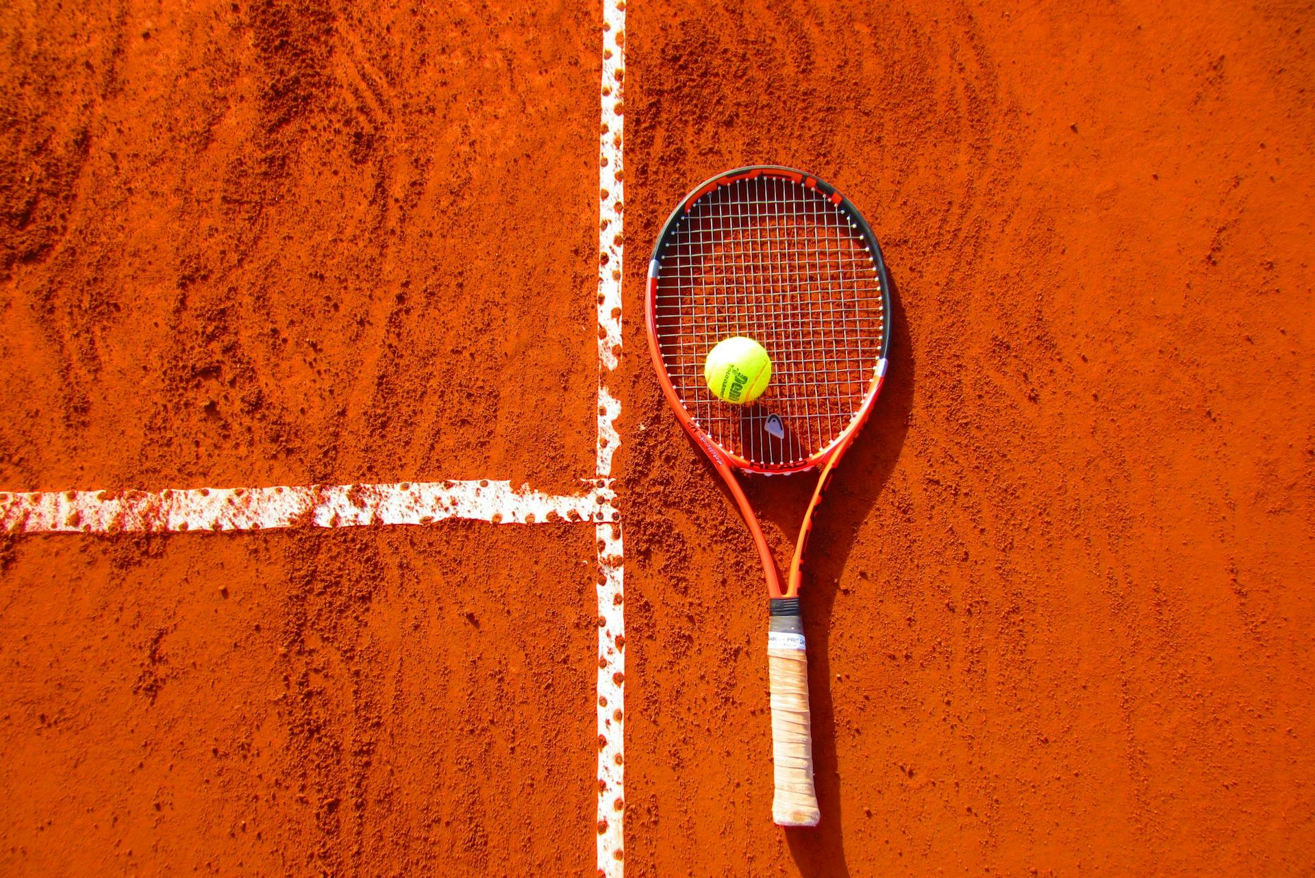 Tennis Ball on Tennis Racket on Floor Tennis Ball on Tennis Racket on Floor
