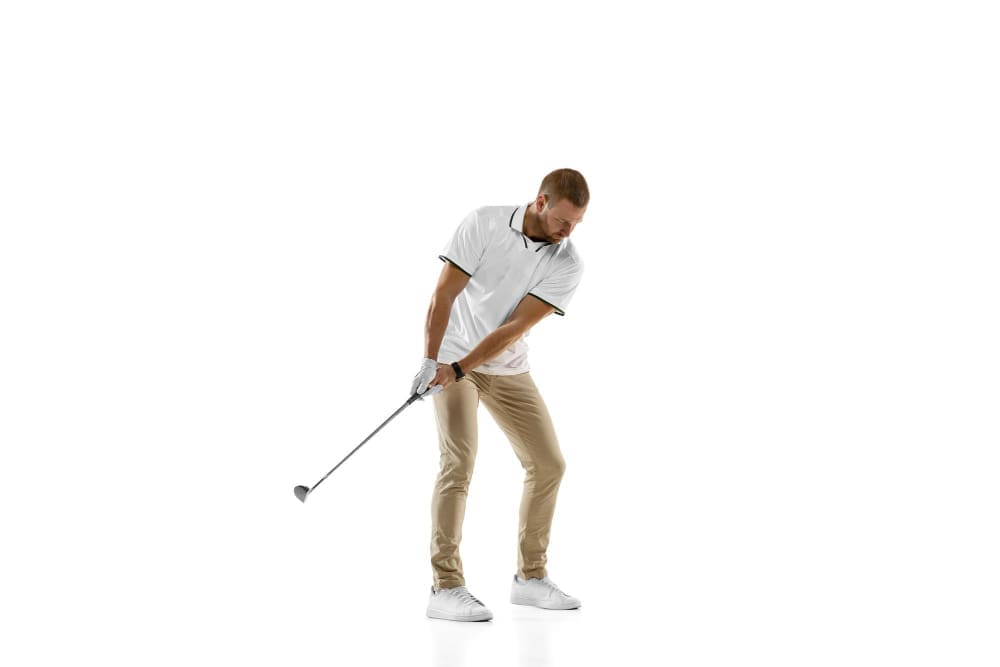 Golf player in a white shirt practicing, playing isolated on white studio background Golf player in a white shirt practicing, playing isolated on white studio background